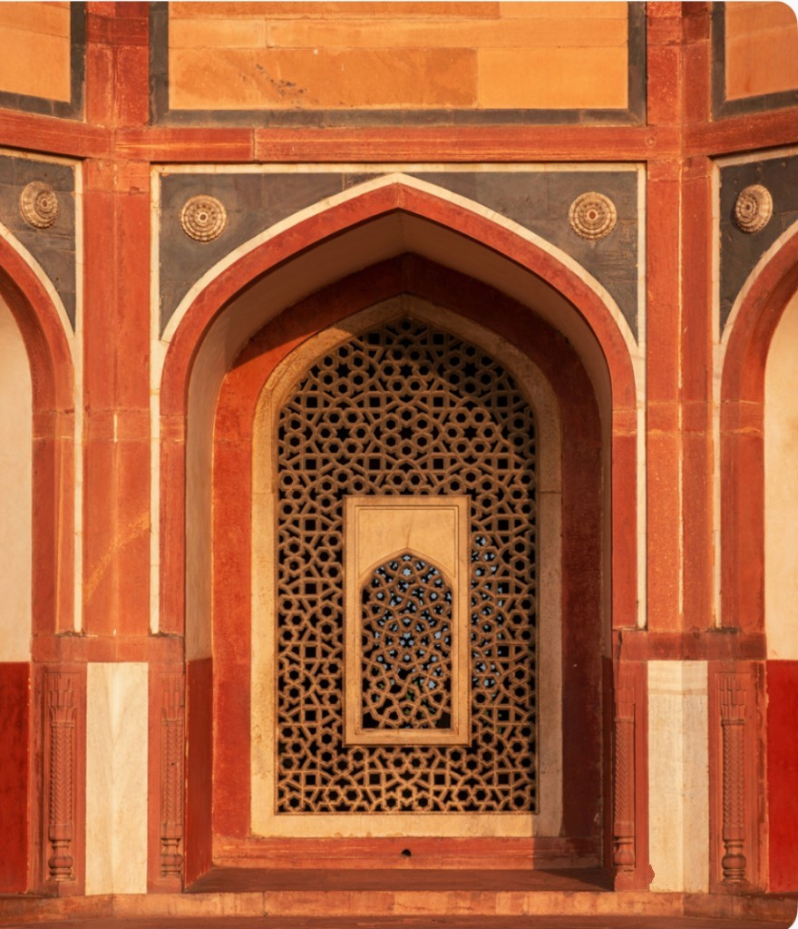 A carved sandstone arch, open like a doorway into the light.